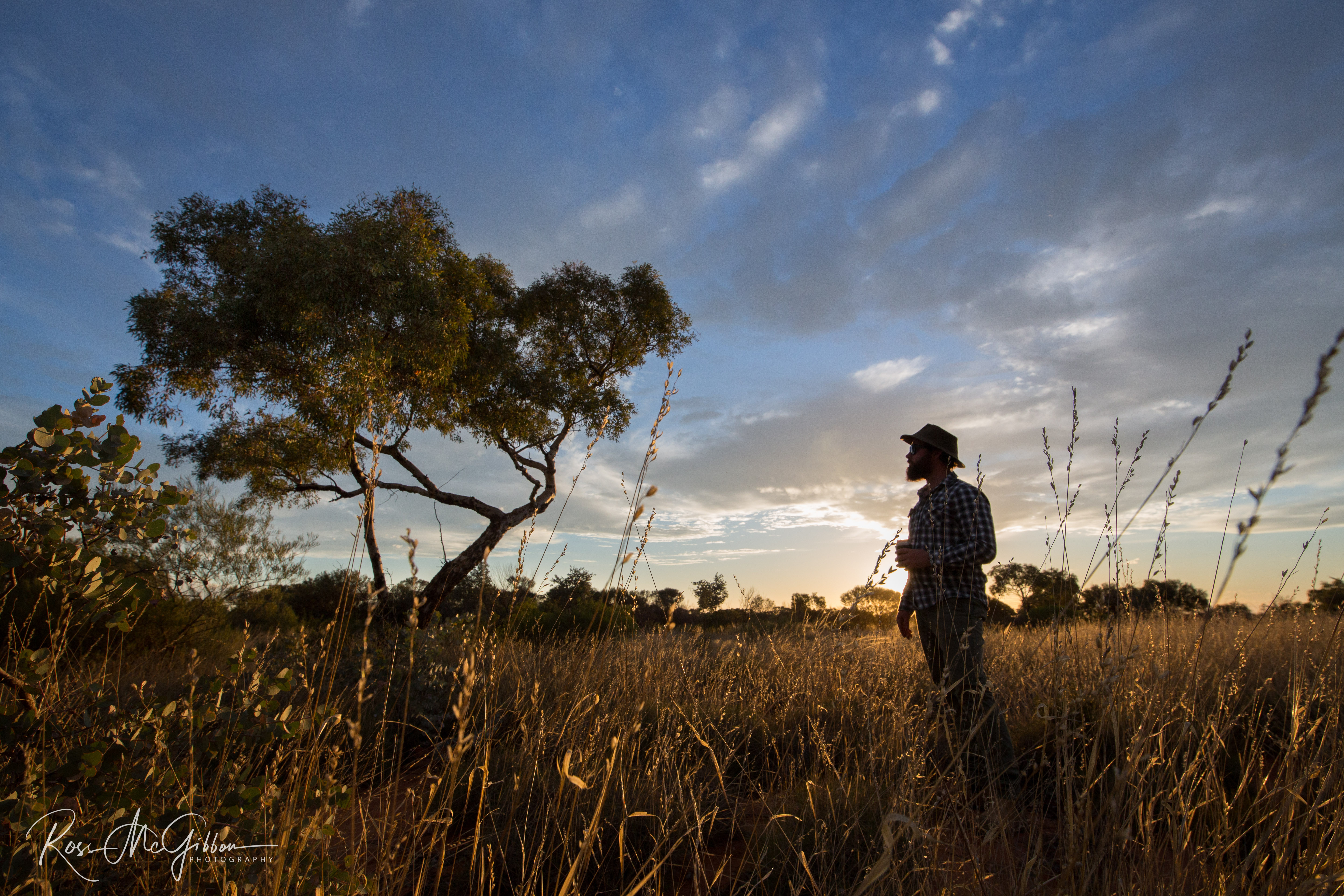 Tim enjoying a well-earned drink as the sun sets over the Australian outback after a day searching for taipans.