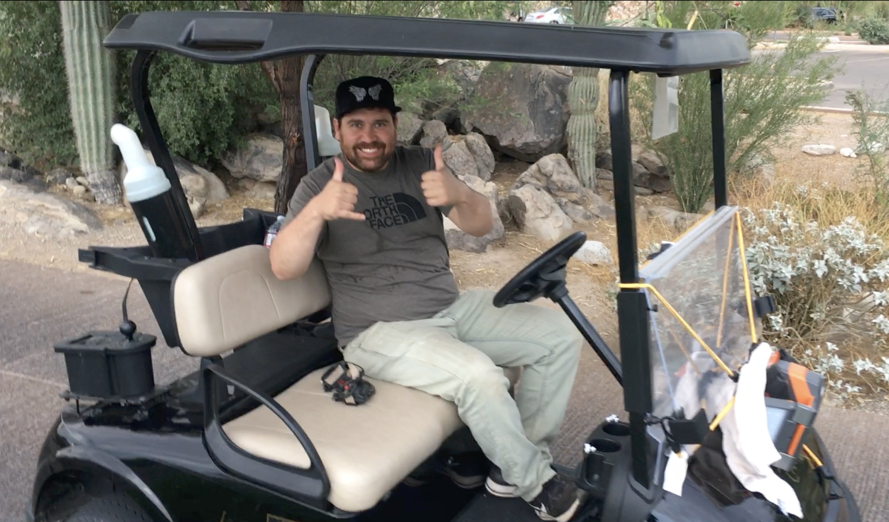 Dan sitting on a golf cart during a nighttime reptile survey in Arizona, searching for rattlesnakes and Gila Monsters.